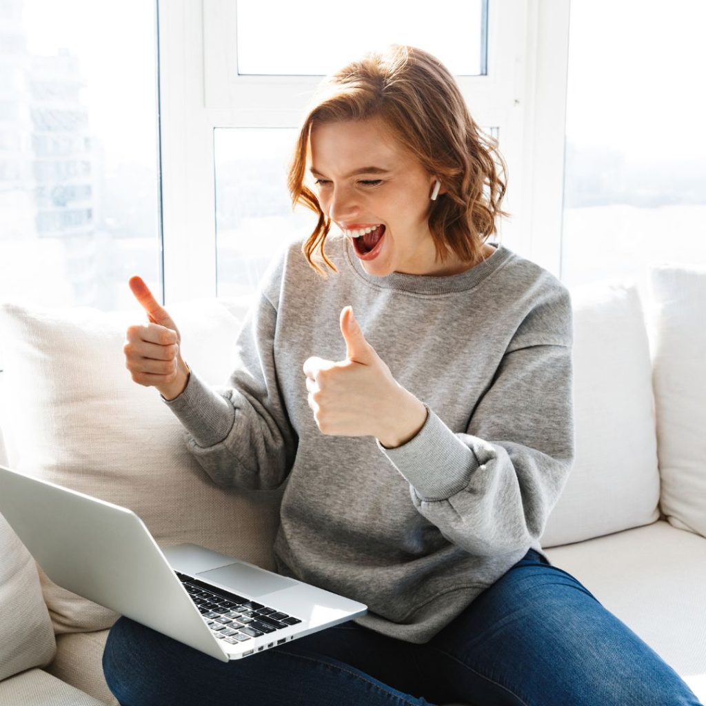 Woman happy video calling using laptop