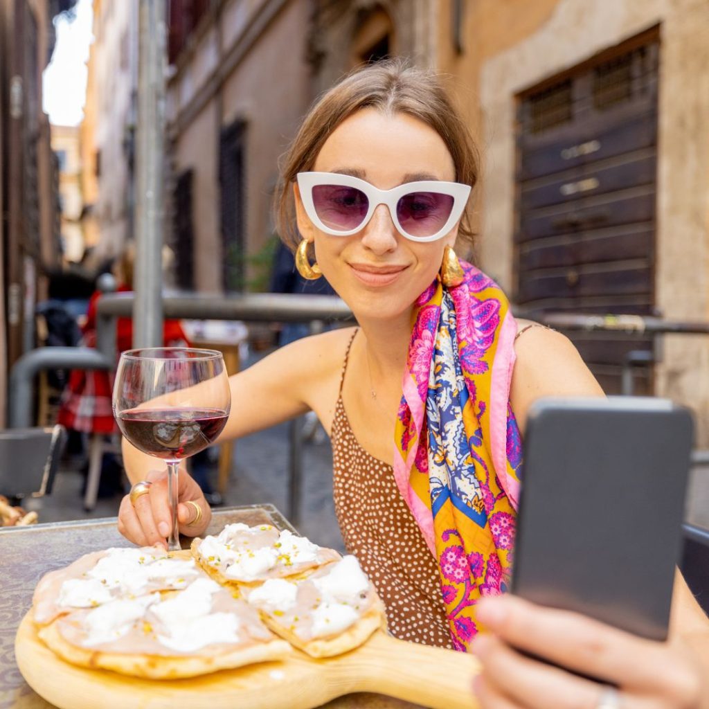 Woman wearing shades and taking a selfie