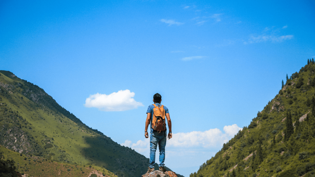 guy between two mountains on an adventure