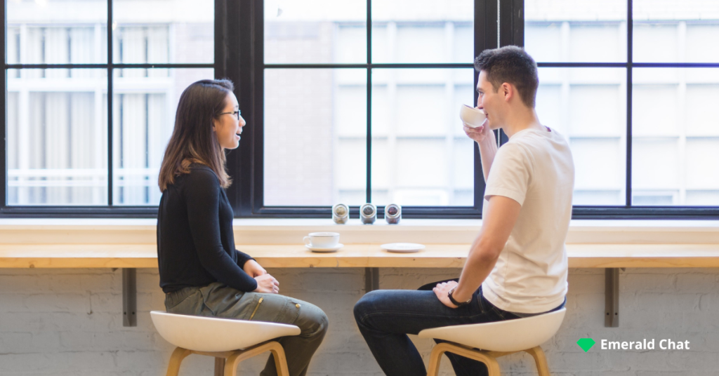 image of a male and female facing each other while sitting around a table