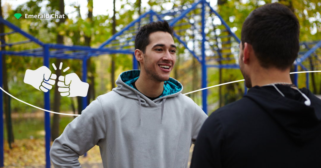 Two people having a light conversation outdoors, capturing how falling for someone you barely talk to can begin with just a small, meaningful moment