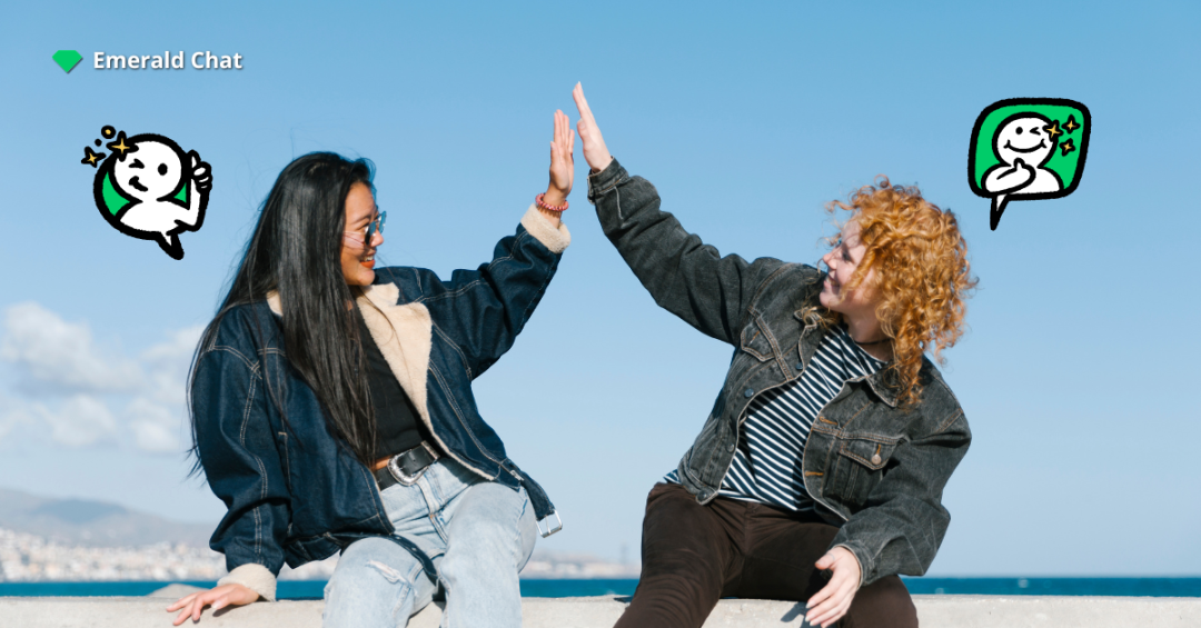 Two people sharing a joyful high-five by the sea, symbolizing how small interactions can spark falling for someone you barely talk to