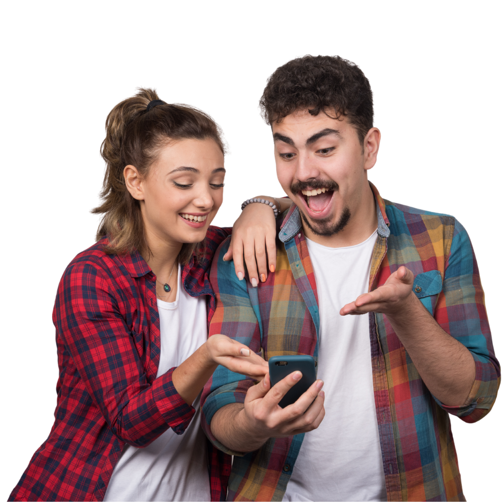 Two people smiling while looking at a phone together